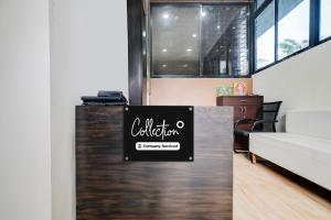 a sign on a counter in a room at Super Collection O Indore Near Omax City 1 in Kanāria