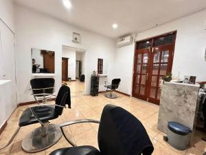 a salon with black chairs in a room at Sunset INN by Pro-Ema in Dili