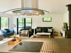 a living room with a couch and a table at Summer House 300 M From Beach in Hals