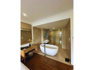 a bathroom with a bath tub and a shower at Nhật Tân Hotel Hà Nội - Lê Trọng Tấn in Hanoi
