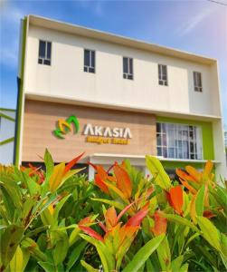 a building with a tree in front of it at Akasia Budget Hotel in Ulujami