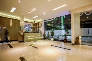 a lobby of a building with a large window at Akasia Budget Hotel in Ulujami
