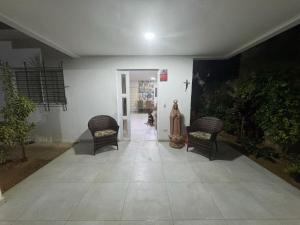 a hallway with two chairs and a dog in a room at Casa do carnaval - Olinda in Olinda
