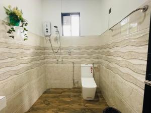 a bathroom with a toilet and a shower at Ella White Tea Garden Hotel in Ella +58 photos
