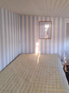 a bedroom with a large bed in a room at Architect-Designed Cottage By The Water in Middelfart +3 photos