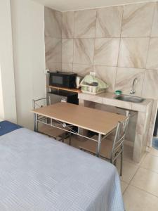 a small kitchen with a table and a sink at Centro de Tacna quinto piso in Tacna