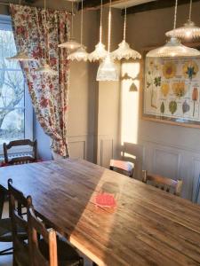 a dining room with a wooden table and chairs at House And Playful Barn in Verrières +28 photos
