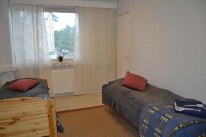 En eller flere senge i et værelse på Apartment Paasikivi