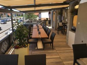 a restaurant with a table and chairs on a patio at Hotel Restaurant Jura in Kerzers