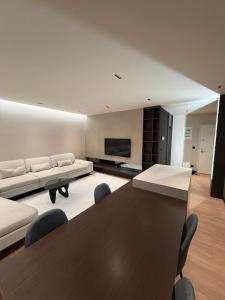 a large living room with a table and a couch at Skyline Exclusive 2 in Peje