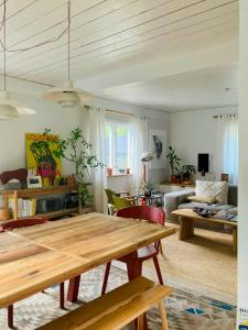 a living room with a table and a couch at Cosy House Surrounded By Nature in Diö