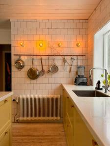 a kitchen with a sink and utensils on the wall at Cosy House Surrounded By Nature in Diö