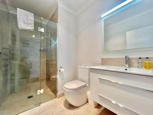a bathroom with a toilet and a glass shower at Matariki Star in Lake Tekapo +23 photos