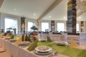 a long table with plates and napkins on it at Pokoje BALDI Benelux in Skoczów