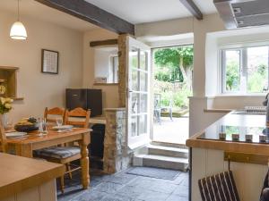 a kitchen and dining room with a door leading to a patio at Rose Cottage - Uk34067 in Grassington +12 photos