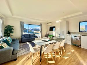 a kitchen and living room with a table and chairs at Matariki Star in Lake Tekapo