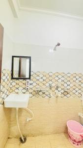 a bathroom with a sink and a mirror on the wall at Hotel MDP Ayodhya Near Rammandir Ayodhya in Ayodhya