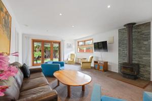 a living room with a couch and a wood stove at Andrea and Nigel's Beach House in Cape Woolamai
