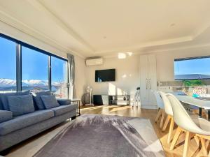 a living room with a couch and a table at Matariki Star in Lake Tekapo