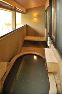 a small car parked in a room with a bath tub at Morinoryotei Biei in Biei +28 photos