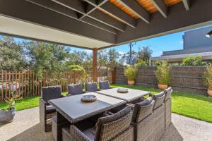 an outdoor patio with a table and chairs at Stylish Townhouse Opposite Golfcourse in Cowes
