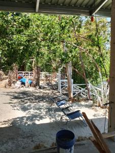 a couple of chairs sitting under a tree at Aiko Beach Isla Sunrise Resort in Bolinao +29 photos