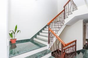 a staircase in a house with a potted plant at Retreat Serviced Apartment in Kathmandu