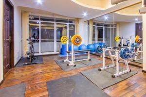 a gym with several exercise equipment in a room at Retreat Serviced Apartment in Kathmandu