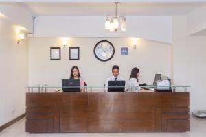 a group of people sitting at a desk with laptops at Retreat Serviced Apartment in Kathmandu +93 photos