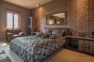 a bedroom with a bed with a dog laying on it at Villa Malom Luxury Resort in Pusztazámor