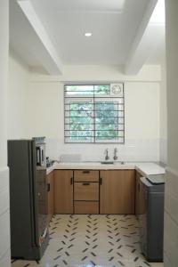 a kitchen with a sink and a window at Jo Homes Apartments in Alwaye