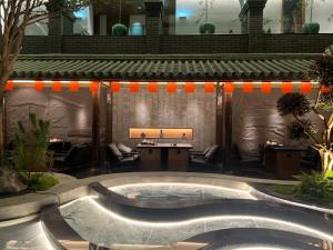 a pool in a courtyard with a table and chairs at Return Courtyard Hotel in Chengdu