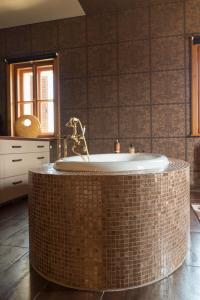 a bathroom with a large tub in a room at Villa Malom Luxury Resort in Pusztazámor +40 photos