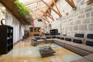 a living room with a couch and a glass table at Villa Malom Luxury Resort in Pusztazámor
