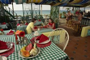 two people sitting at a table at a restaurant at Legends Beach Resort in Negril