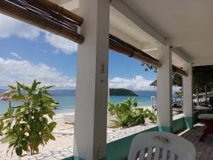 a view of the beach from the porch of a beach house at Casa Nenen in Romblon