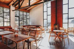 a restaurant with tables and chairs and windows at The Himalayan Tyangboche in Thyāngboche