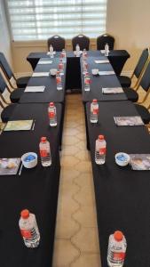 a row of tables with bottles of water on them at White House River Manor in Upington +27 photos