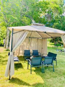 a gazebo with chairs and a table under it at White House River Manor in Upington