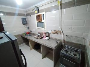 a small kitchen with a counter and a stove at Pink Horizon Homestay - for Men ONLY in Dumyāţ al Jadīdah +10 photos