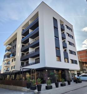 a large white building with plants in front of it at Skyline Exclusive 2 in Peje