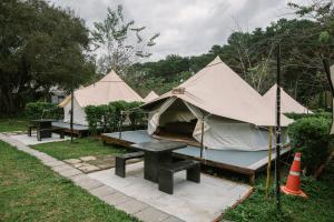 a group of tents with a picnic table at Inthanon Mountain Camp in Ban Na Yang