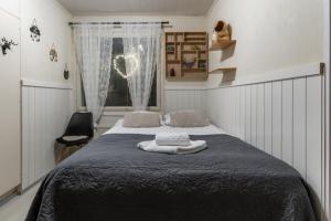 a bedroom with a bed and a window at Rovaniemi Spacious Lapland Vacation Home with Private Sauna & Lappish Fire Hut in Rovaniemi