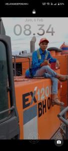 a man sitting on top of an orange truck at Kotabaru in Gununganjar