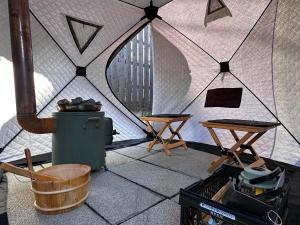 a tent with two tables and a table and chairs at Little Seagull by SANA in Tateyama