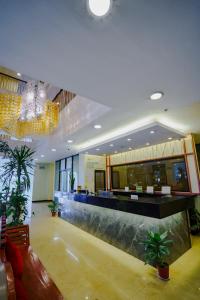 a lobby with a bar with plants in it at Olive Town Center and Hotel in Baguio