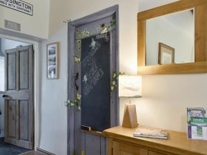 a door with a sign on it in a room at Rose Cottage - Uk34067 in Grassington
