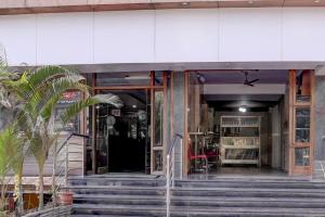 a building with stairs in front of a store at Super Townhouse Oak Dharwad New Bus Terminal Formerly Hotel Aditya Inn in Dhārwād +37 photos