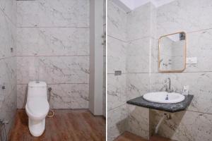a bathroom with a toilet and a sink at Super Townhouse Oak Dharwad New Bus Terminal Formerly Hotel Aditya Inn in Dhārwād