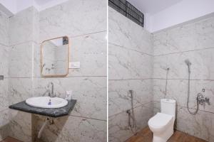 a bathroom with a sink and a toilet at Super Townhouse Oak Dharwad New Bus Terminal Formerly Hotel Aditya Inn in Dhārwād
